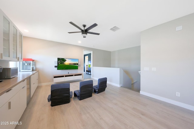 9750 E Radioactive Dr, Mesa, AZ 85212 - living room featuring light wood-style flooring, a ceiling fan, baseboards, and recessed lighting
