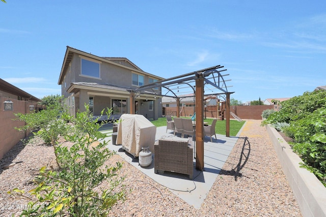 9750 E Radioactive Dr, Mesa, AZ 85212 - back of house featuring an outdoor hangout area, a playground, a fenced backyard, stucco siding, and a patio area
