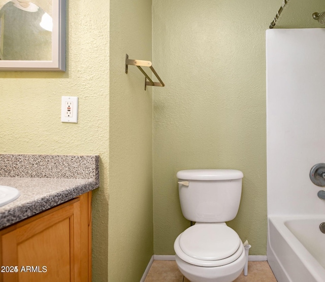 bathroom featuring a tub to relax in, tile patterned flooring, vanity, and toilet