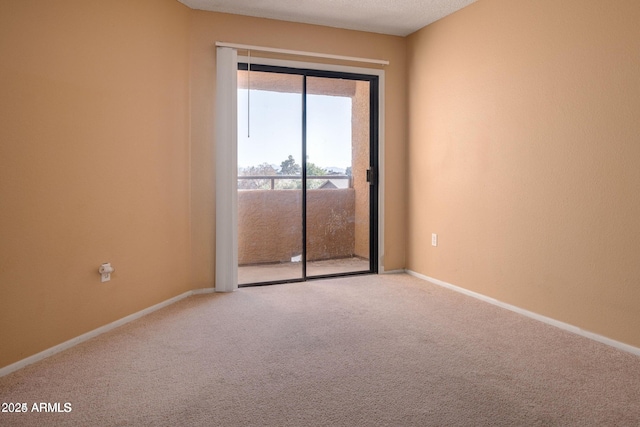 unfurnished room featuring a textured ceiling and carpet flooring