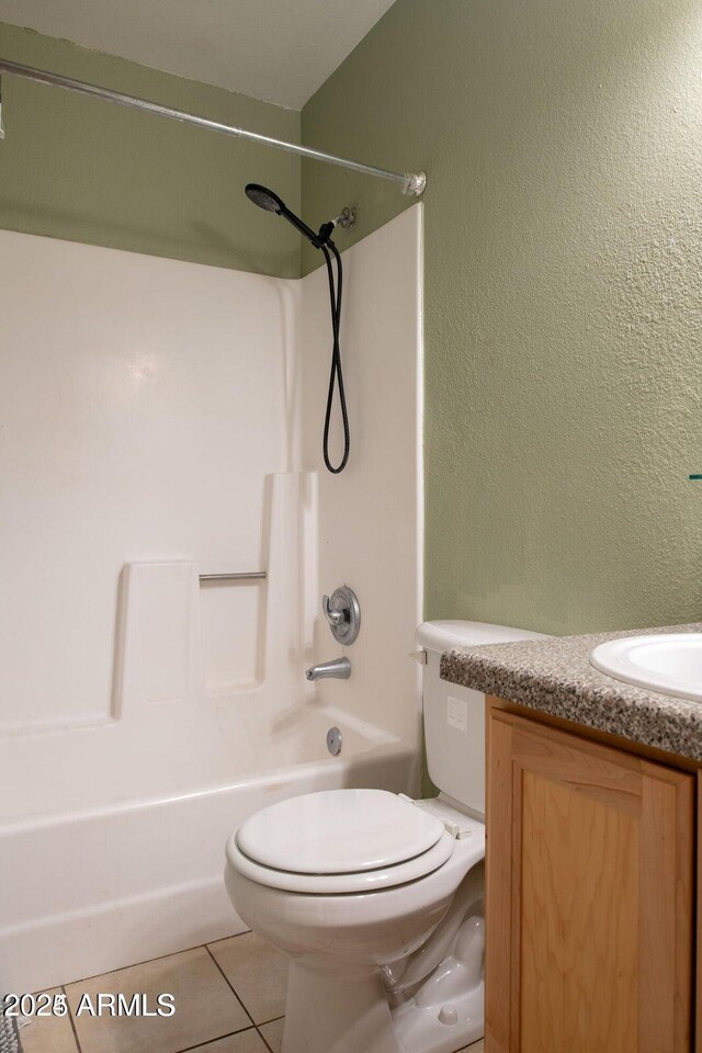 full bathroom featuring toilet, tile patterned floors, bathing tub / shower combination, and vanity