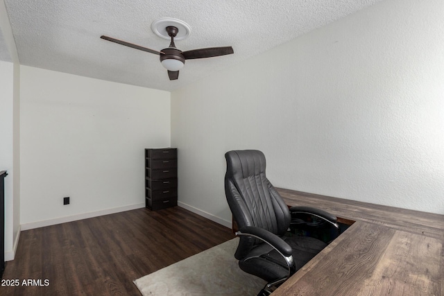 office space with ceiling fan, dark hardwood / wood-style floors, and a textured ceiling