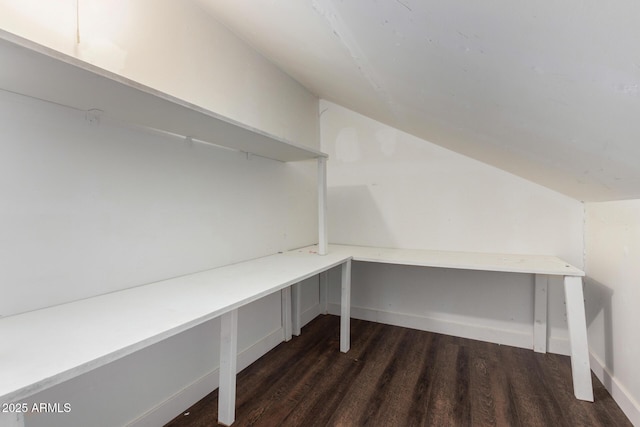 unfurnished office featuring lofted ceiling and dark hardwood / wood-style floors