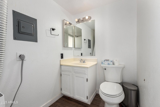 bathroom with vanity, hardwood / wood-style floors, and toilet