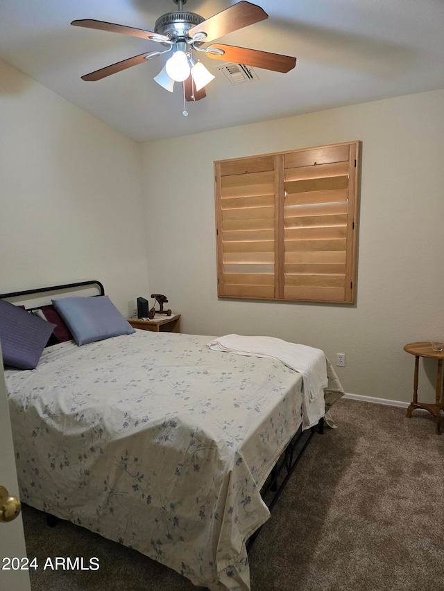 bedroom featuring ceiling fan and dark colored carpet