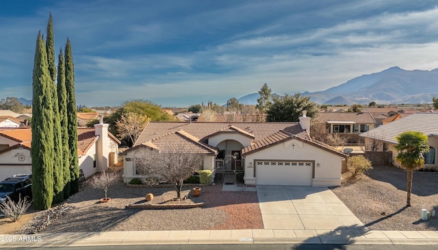 view of front facade featuring a mountain view and a garage