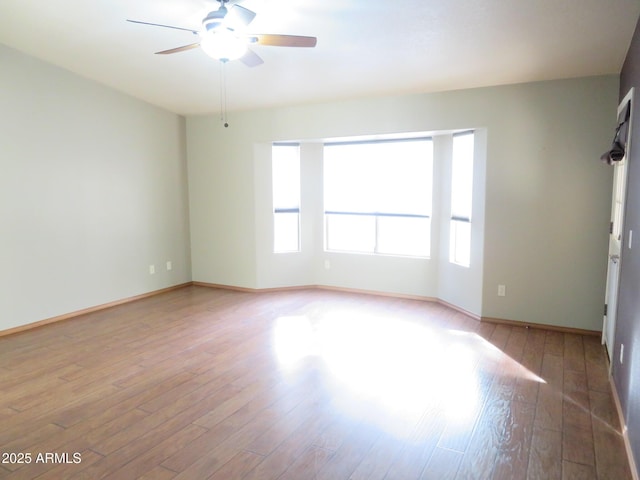 spare room featuring light hardwood / wood-style floors and ceiling fan