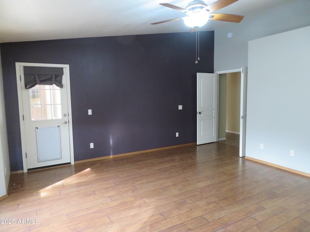 unfurnished room featuring ceiling fan, light hardwood / wood-style flooring, and lofted ceiling