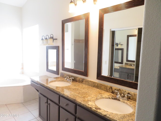 bathroom with a bath, tile patterned floors, and vanity