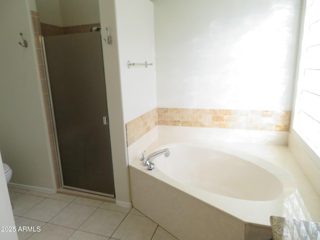 bathroom with toilet, shower with separate bathtub, and tile patterned floors