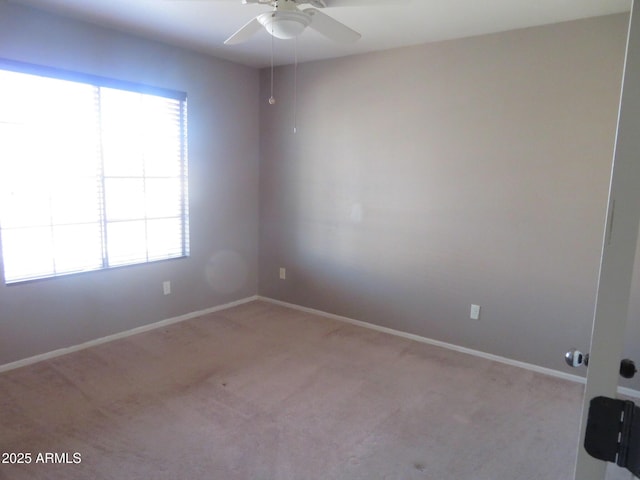 carpeted empty room featuring ceiling fan