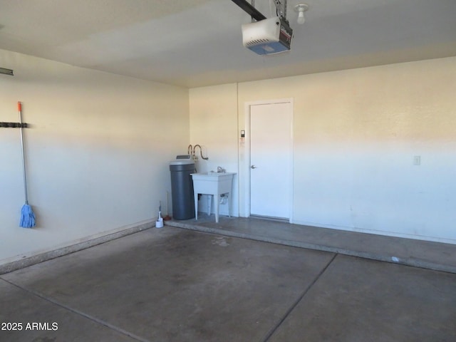 garage featuring sink and a garage door opener