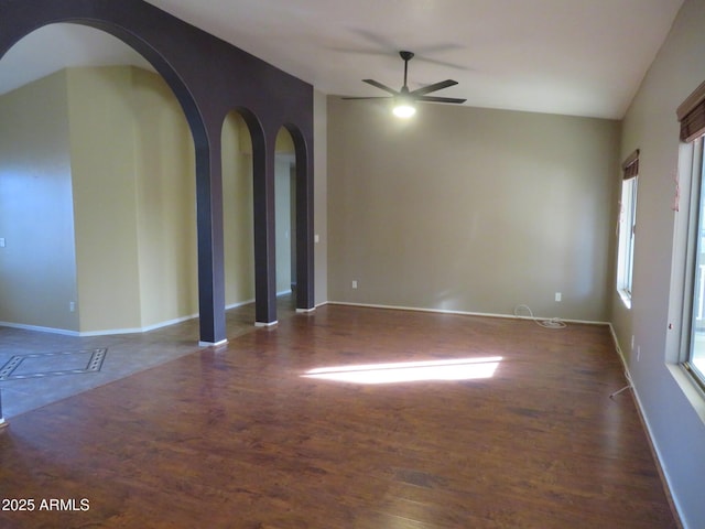 spare room featuring ceiling fan and dark wood-type flooring