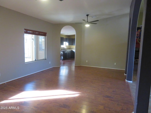 empty room featuring ceiling fan and dark hardwood / wood-style floors