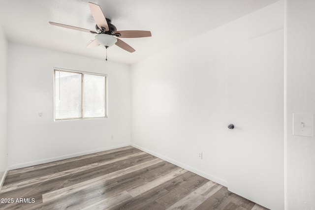 unfurnished room featuring ceiling fan, baseboards, and wood finished floors