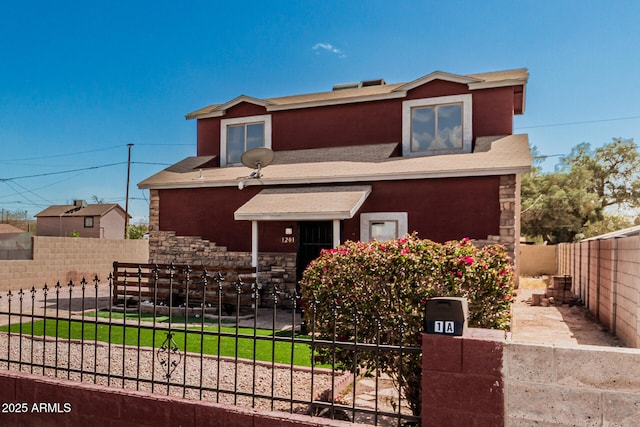 view of front facade featuring fence private yard