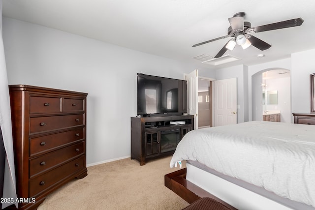 carpeted bedroom featuring connected bathroom and ceiling fan