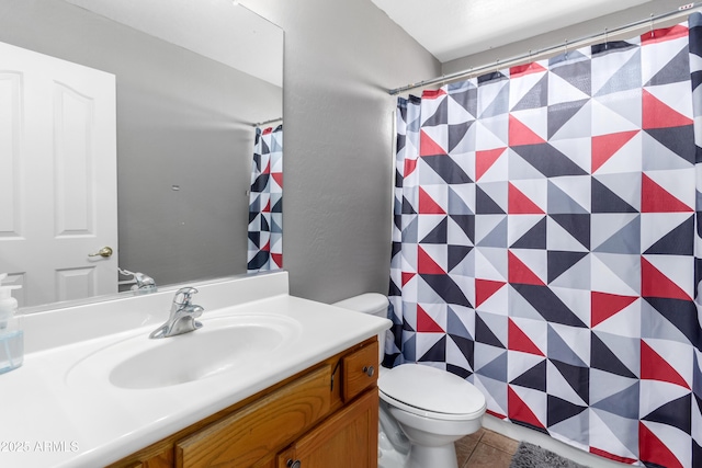 bathroom featuring tile patterned flooring, vanity, and toilet