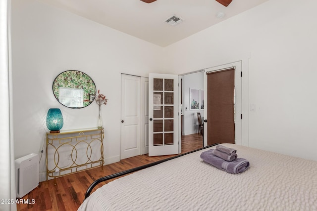 bedroom featuring visible vents and wood finished floors