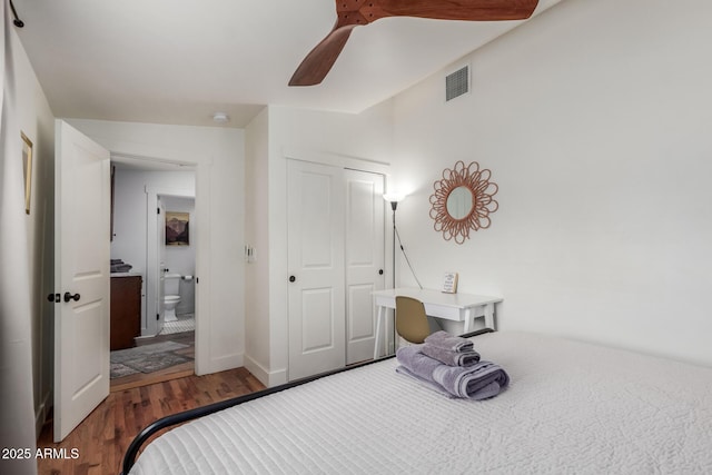 bedroom with visible vents, a ceiling fan, wood finished floors, a closet, and lofted ceiling