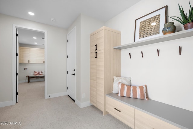 mudroom with recessed lighting and baseboards