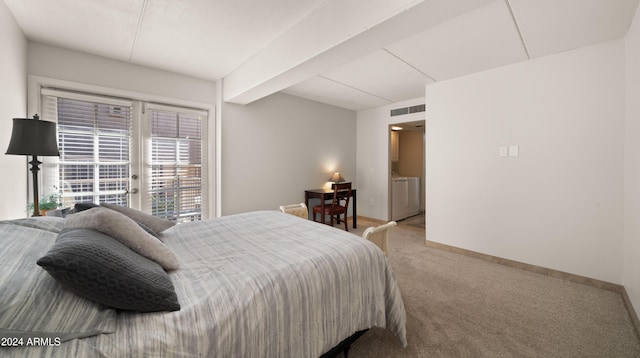 carpeted bedroom featuring independent washer and dryer