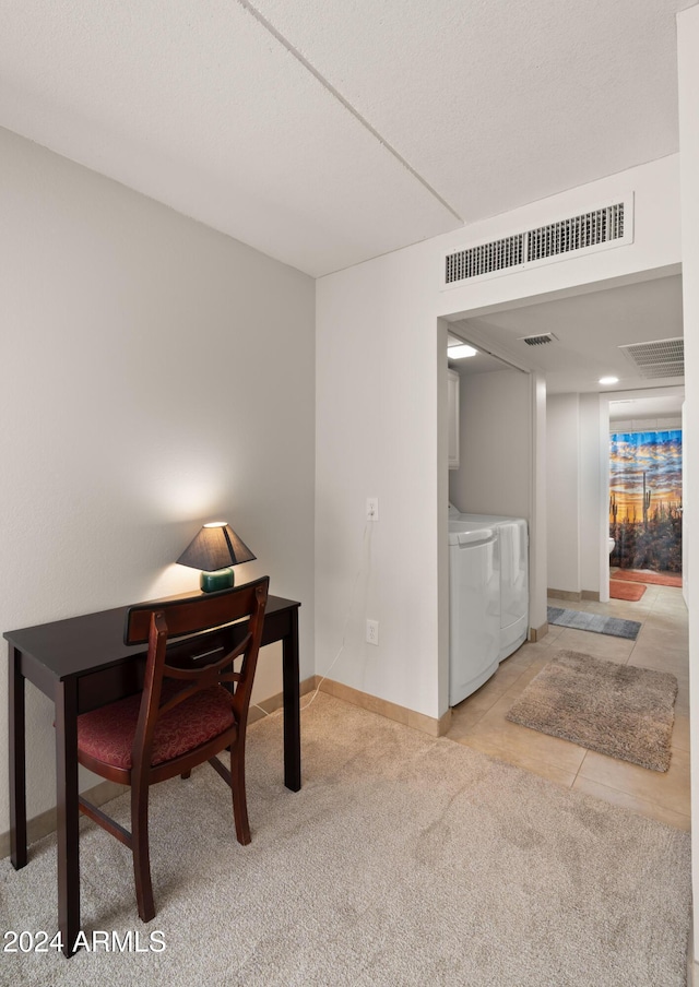 office space featuring separate washer and dryer and light carpet