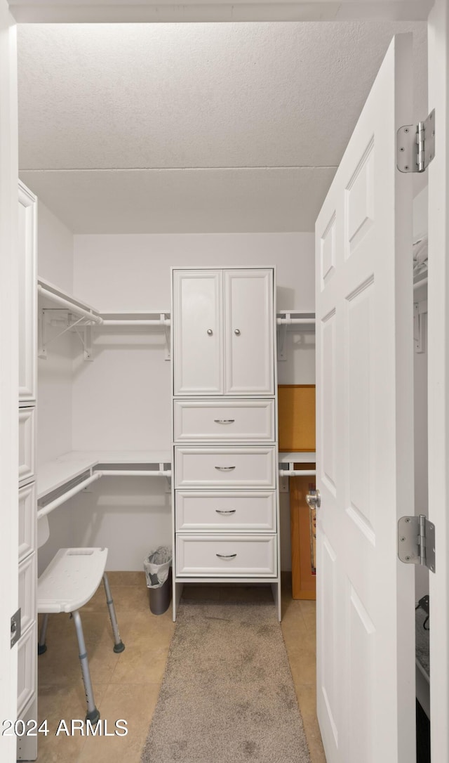 walk in closet featuring light tile patterned floors