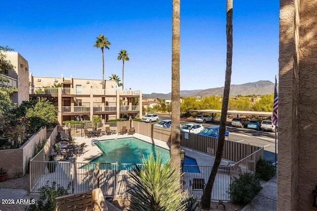 view of swimming pool with a mountain view and a patio