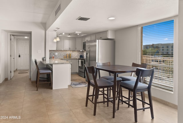 dining area featuring light tile patterned floors