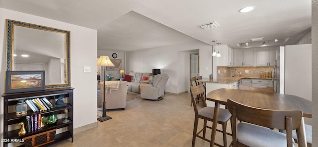 tiled dining room featuring sink