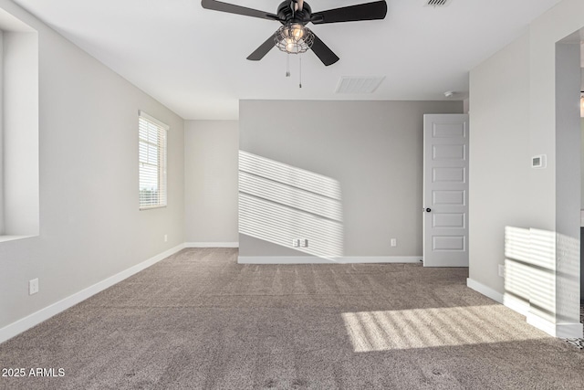 carpeted spare room featuring ceiling fan