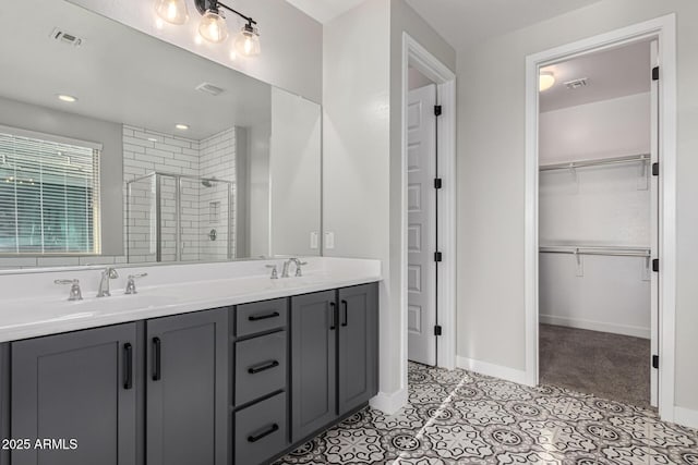 bathroom with vanity, tile patterned flooring, and a shower with door