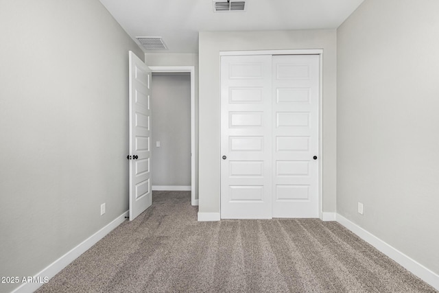 unfurnished bedroom with a closet and carpet