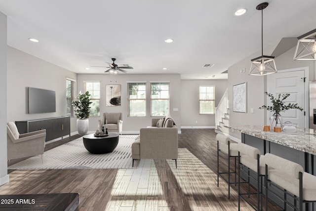 living room with dark hardwood / wood-style floors and ceiling fan