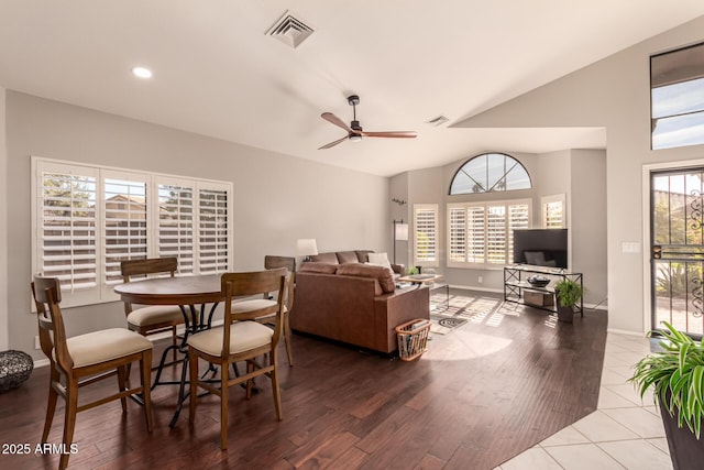 dining room featuring vaulted ceiling, wood-type flooring, and ceiling fan