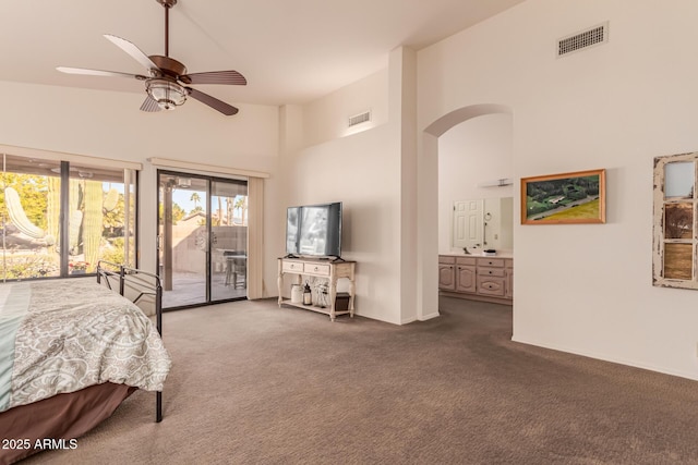 carpeted bedroom with ceiling fan, high vaulted ceiling, ensuite bath, and access to outside