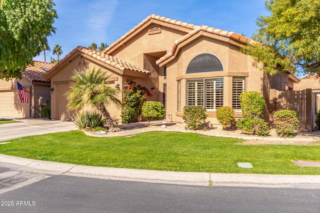 mediterranean / spanish-style house with a garage and a front lawn