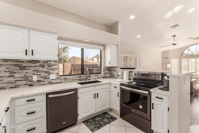 kitchen with stainless steel appliances, kitchen peninsula, sink, and white cabinets