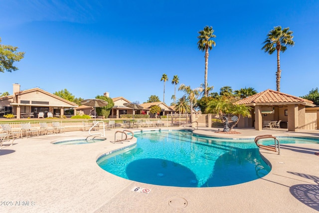 view of pool featuring a patio and a community hot tub