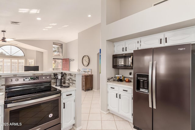 kitchen featuring light tile patterned flooring, white cabinetry, lofted ceiling, ceiling fan, and stainless steel appliances