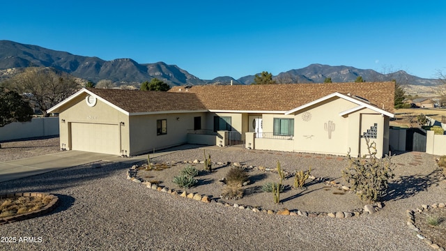 ranch-style house featuring a garage and a mountain view