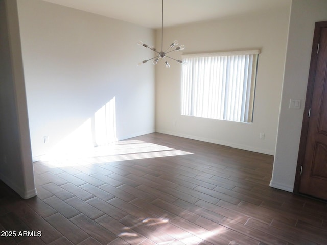 unfurnished room with a chandelier