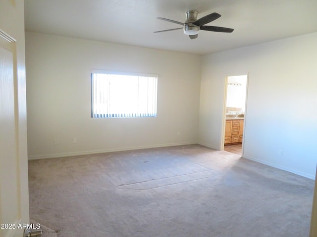 carpeted spare room with ceiling fan