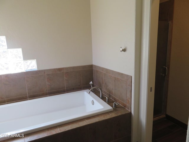 bathroom featuring separate shower and tub