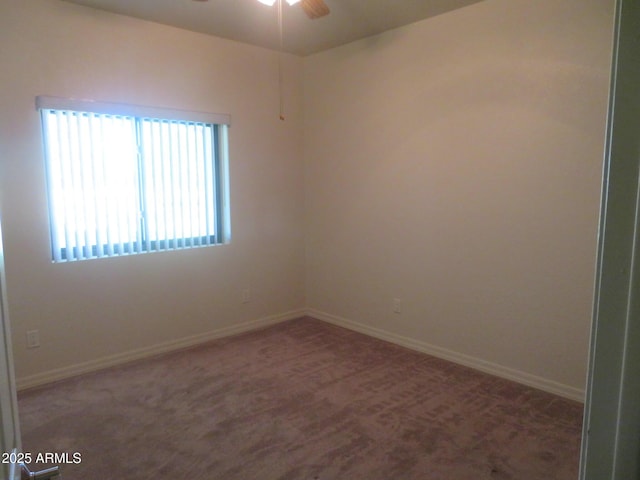 carpeted empty room featuring ceiling fan