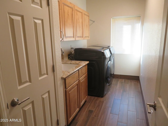 laundry room with cabinets, sink, dark hardwood / wood-style flooring, and washing machine and dryer