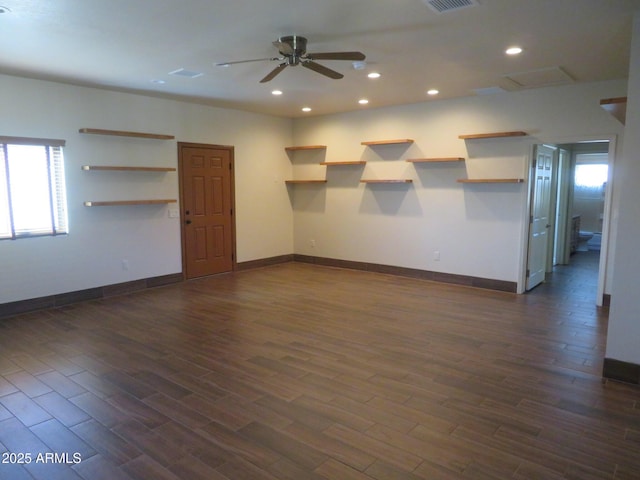 empty room featuring dark wood-type flooring and ceiling fan