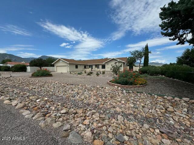 view of front of home with a garage and a mountain view