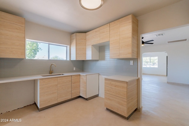 kitchen featuring ceiling fan, sink, light brown cabinets, decorative backsplash, and light tile patterned floors